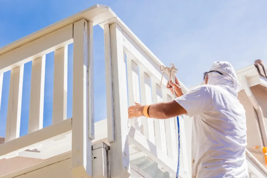 House painter spray painting a deck of a home 2024 09 11 21 50 31 utc